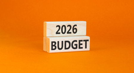2026 Budget symbol. Concept words 2026 Budget on beautiful wooden blocks. Beautiful orange paper...