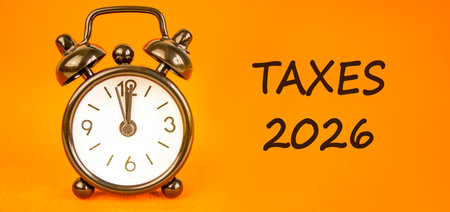 Taxes 2026 new year symbol. Concept words Taxes 2026 on beautiful orange paper. Beautiful orange...