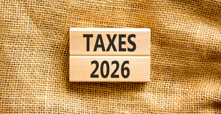 Taxes 2026 new year symbol. Concept words Taxes 2026 on beautiful wooden blocks. Beautiful canvas...