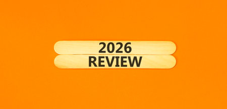 2026 Review symbol. Concept words 2026 Review on beautiful wooden sticks. Beautiful orange paper...