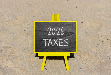 2026 taxes new year symbol. Concept words 2026 taxes on beautiful black blackboard. Beautiful sand beach background. Business and 2026 taxes new year concept. Copy space.の写真素材