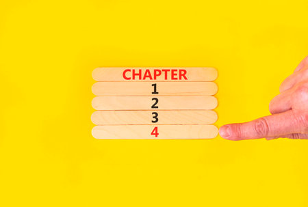 Time to chapter 4 symbol. Concept word Chapter 1 2 3 4 on beautiful wooden sticks. Businessman's hand. Beautiful yellow background. Business planning and time to chapter 4 concept. Copy space.の写真素材