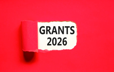 Grants 2026 symbol. Concept words Grants 2026 on beautiful white paper. Beautiful red paper background. Business and grants 2026 concept. Copy space.の写真素材