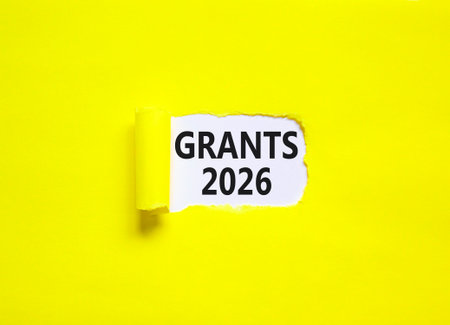Grants 2026 symbol. Concept words Grants 2026 on beautiful white paper. Beautiful yellow paper background. Business and grants 2026 concept. Copy space.の写真素材