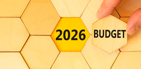 2026 Budget symbol. Concept words 2026 Budget on beautiful wooden puzzles. Beautiful wooden puzzles background. Businessman's hand. Business and 2026 budget concept. Copy space.の写真素材