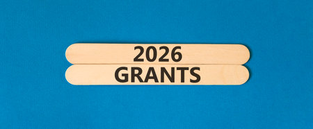 2026 Grants symbol. Concept words 2026 Grants on beautiful wooden sticks. Beautiful blue paper background. Business and 2026 grants concept. Copy space.の写真素材