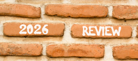 2026 Review symbol. Concept words 2026 Review on beautiful brown brick wall. Beautiful brown brick wall background. Business and 2026 review concept. Copy space.の写真素材