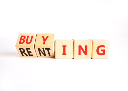 Buying or renting symbol. Concept words Buying or Renting on beautiful wooden cubes. Beautiful white table white background. Business, buying or renting concept. Copy space.の写真素材