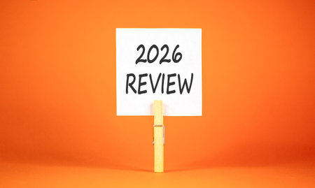 2026 Review symbol. Concept words 2026 Review on beautiful white paper on wooden clothespin....