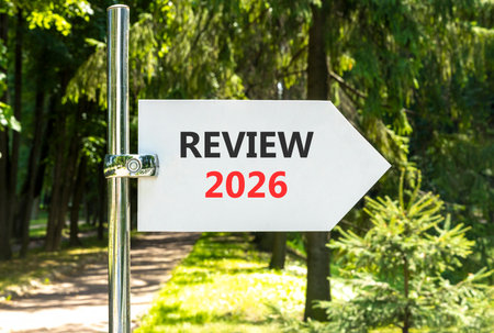Review 2026 symbol. Concept words Review 2026 on beautiful white road sign. Beautiful summer green forest garden background. Business and review 2026 concept. Copy space.の写真素材