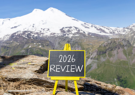 2026 Review symbol. Concept words 2026 Review on beautiful black blackboard. Beautiful mountain...