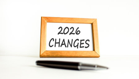 2026 Changes symbol. Concept words 2026 Changes on beautiful wooden picture frame. Beautiful white paper background. Beautiful black pen. Business and 2026 changes concept. Copy space.の写真素材