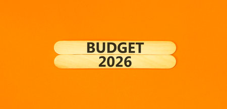 Budget 2026 symbol. Concept words Budget 2026 on beautiful wooden sticks. Beautiful orange paper...