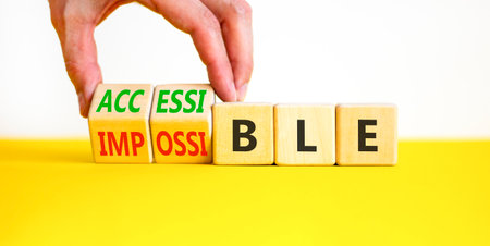 Accessible or impossible symbol. Concept words Accessible or Impossible on beautiful wooden blocks. Beautiful white and yellow background. Business accessible or impossible concept. Copy space.の写真素材
