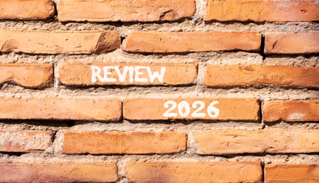 Review 2026 symbol. Concept words Review 2026 on beautiful brown brick wall. Beautiful brown brick...
