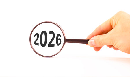 Business concept of 2026 new year symbol. Concept number 2026 Happy new year in black magnifying glass. Businessman's hand. Beautiful white background. Business 2026 happy new year concept. Copy spaceの写真素材