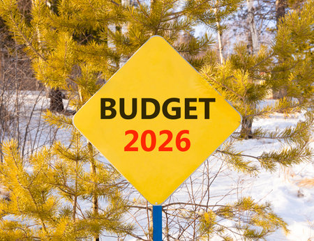 Budget 2026 symbol. Concept words Budget 2026 on beautiful yellow road sign. Beautiful winter forest background. Business and budget 2026 concept. Copy space.の写真素材
