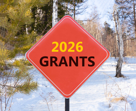 2026 Grants symbol. Concept words 2026 Grants on beautiful red road sign. Beautiful winter forest...