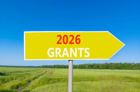 2026 Grants symbol. Concept words 2026 Grants on beautiful yellow road sign. Beautiful green grass...