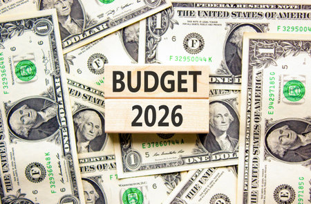 Budget 2026 symbol. Concept words Budget 2026 on beautiful wooden blocks. Beautiful dollar bills background. Dollar bills. Business and budget 2026 concept. Copy space.の写真素材