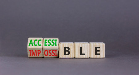 Accessible or impossible symbol. Concept words Accessible or Impossible on beautiful wooden blocks. Beautiful gray table gray background. Business accessible or impossible concept. Copy space.の写真素材