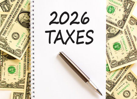 2026 taxes new year symbol. Concept words 2026 taxes on beautiful white note. Beautiful dollar bills background. Black pen. Dollar bills. Business and 2026 taxes new year concept. Copy space.の写真素材