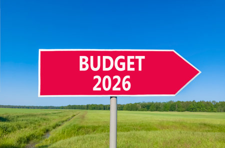Budget 2026 symbol. Concept words Budget 2026 on beautiful red road sign. Beautiful green grass field forest and blue sky background. Business and budget 2026 concept. Copy space.の写真素材