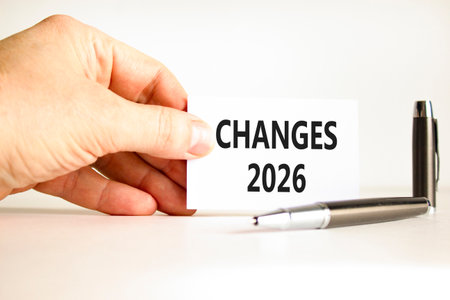 Changes 2026 symbol. Concept words Changes 2026 on beautiful white card. Beautiful white paper background. Businessman's hand. Business and changes 2026 concept. Copy space.の写真素材