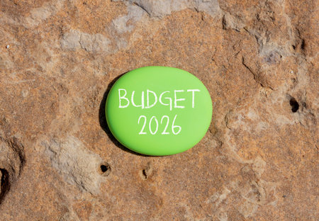 Budget 2026 symbol. Concept words Budget 2026 on beautiful green stone. Beautiful brown stone...