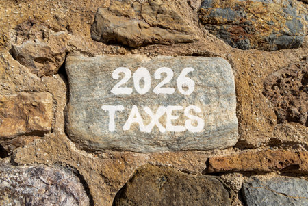 2026 taxes new year symbol. Concept words 2026 taxes on beautiful gray stone on stone wall. Beautiful stone wall background. Business and 2026 taxes new year concept. Copy space.の写真素材