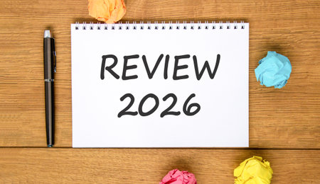 Review 2026 symbol. Concept words Review 2026 on beautiful white note. Beautiful wooden background....