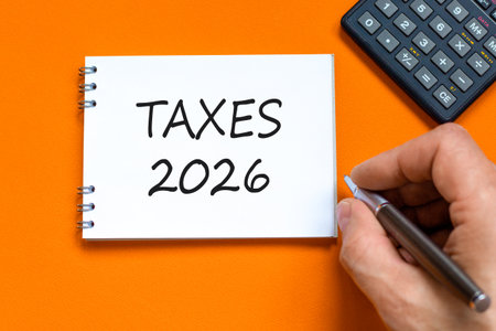 Taxes 2026 new year symbol. Concept words Taxes 2026 on beautiful white note. Black calculator....