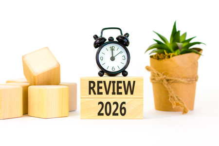 Review 2026 symbol. Concept words Review 2026 on beautiful wooden blocks. Beautiful white paper...