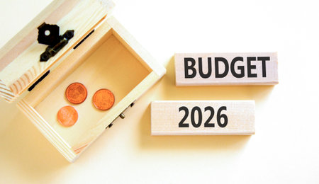 Budget 2026 symbol. Concept words Budget 2026 on beautiful wooden blocks. Beautiful white paper background. Beautiful wooden chest with coins. Business and budget 2026 concept. Copy space.の写真素材