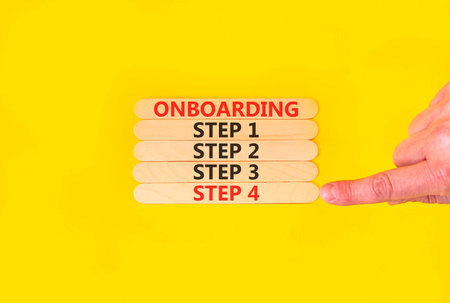 Time to step 4 onboarding symbol. Concept words Onboarding step 4 on beautiful wooden block. Businessman's hand. Beautiful yellow background. Business success step 4 onboarding concept. Copy space.の写真素材