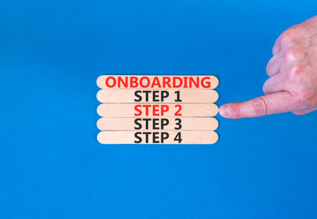 Time to step 2 onboarding symbol. Concept words Onboarding step 2 on beautiful wooden block. Businessman's hand. Beautiful blue background. Business success step 2 onboarding concept. Copy space.の写真素材