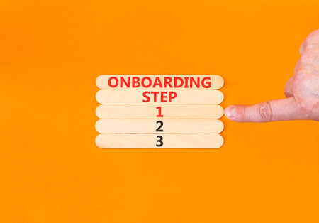 Time to step 1 onboarding symbol. Concept words Onboarding step 1 on beautiful wooden block. Businessman's hand. Beautiful orange background. Business success step 1 onboarding concept. Copy space.の写真素材