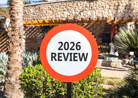 2026 Review symbol. Concept words 2026 Review on beautiful white and red road sign. Beautiful palm...