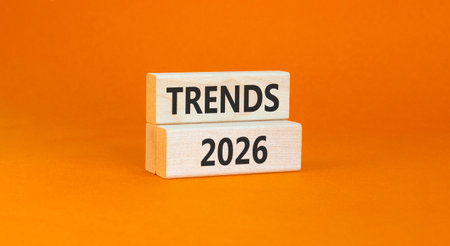 Trends 2026 new year symbol. Concept words Trends 2026 on beautiful wooden blocks. Beautiful orange paper background. Business and Trends 2026 new year concept. Copy space.の写真素材