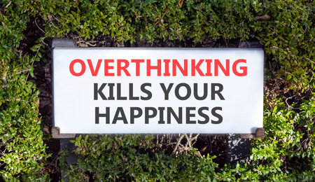 Overthinking kills your happiness symbol. Concept words Overthinking kills your happiness on road sign. Beautiful green trees background. Business overthinking kills happiness concept. Copy space.の写真素材