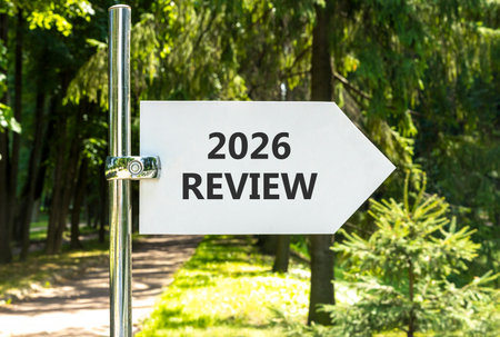 2026 Review symbol. Concept words 2026 Review on beautiful white road sign. Beautiful summer green forest garden background. Business and 2026 review concept. Copy space.の写真素材