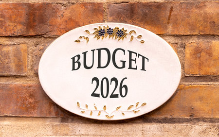 Budget 2026 symbol. Concept words Budget 2026 on beautiful white sign. Beautiful old brown brick wall background. Business and budget 2026 concept. Copy space.の写真素材