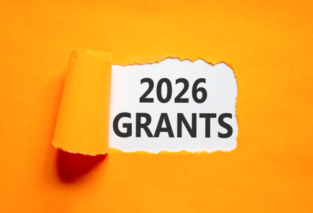 2026 Grants symbol. Concept words 2026 Grants on beautiful white paper. Beautiful orange paper background. Business and 2026 grants concept. Copy space.の写真素材