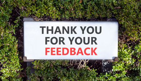 Thank you for your feedback symbol. Concept words Thank you for your feedback on white beautiful road sign. Beautiful green trees background. Business thank you for your feedback concept. Copy space.の写真素材