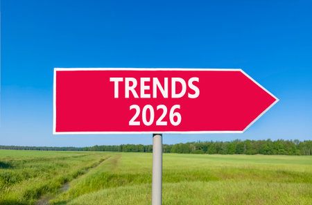 Trends 2026 new year symbol. Concept words Trends 2026 on beautiful red road sign. Beautiful green grass field forest and blue sky background. Business and Trends 2026 new year concept. Copy space.の写真素材
