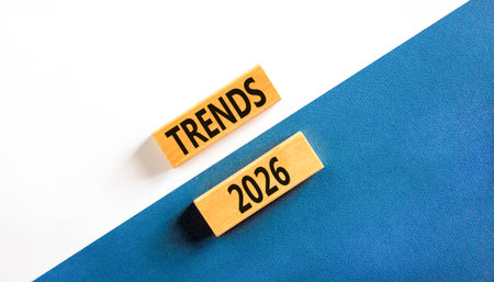 Trends 2026 new year symbol. Concept words Trends 2026 on beautiful wooden blocks. Beautiful white and blue paper background. Business and Trends 2026 new year concept. Copy space.の写真素材