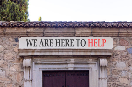 Support, help and we are here to help symbol. Concept words on beautiful white marble sign plate. Beautiful stone wall background. Business concept. Copy space.の写真素材
