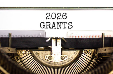 2026 Grants symbol. Concept words 2026 Grants typed on beautiful old retro typewriter. Beautiful white paper background. Beautiful old typewriter. Business and 2026 grants concept. Copy space.の写真素材