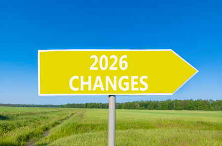 2026 Changes symbol. Concept words 2026 Changes on beautiful yellow road sign. Beautiful green grass field forest and blue sky background. Business and 2026 changes concept. Copy space.の写真素材