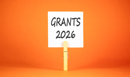 Grants 2026 symbol. Concept words Grants 2026 on beautiful white paper on wooden clothespin....